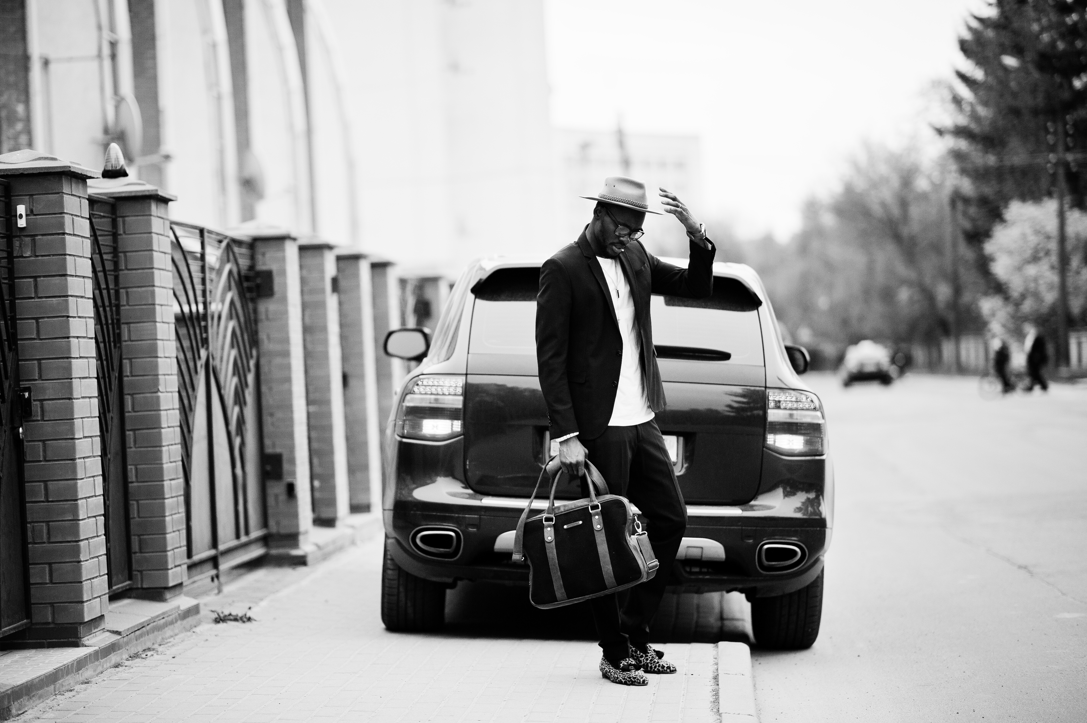 stylish black man at glasses with hat, wear on suit with handbag